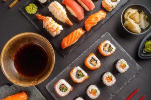 Sushi Set: sushi and sushi rolls on black slate, top view